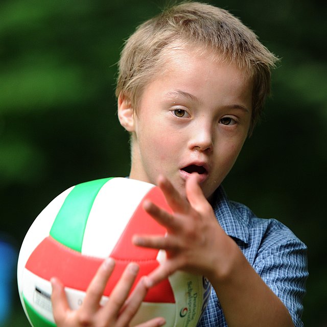 Junge spielt mit Ball beim FSJ Heilpädagogik.
