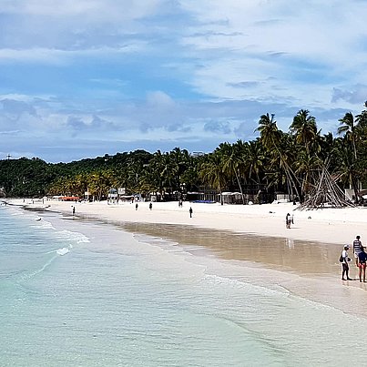 Weißer Strand mit Palmen beim FSJ auf den Philippinen.