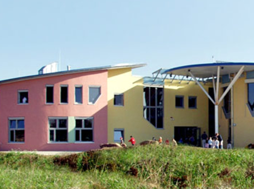 Großes Gebäude des Parzivalzentrums in rosa und gelb beim FSJ